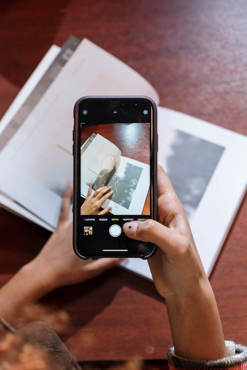 Close-Up Shot of a Person Taking Photo Using a Mobile Phone