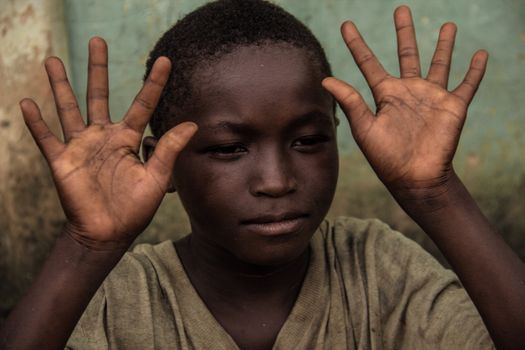 Boy in Dirty Crew Neck Shirt with Hands Up