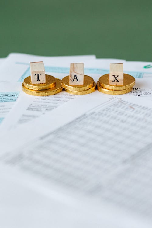 Free Gold Coins on Top of Documents Stock Photo