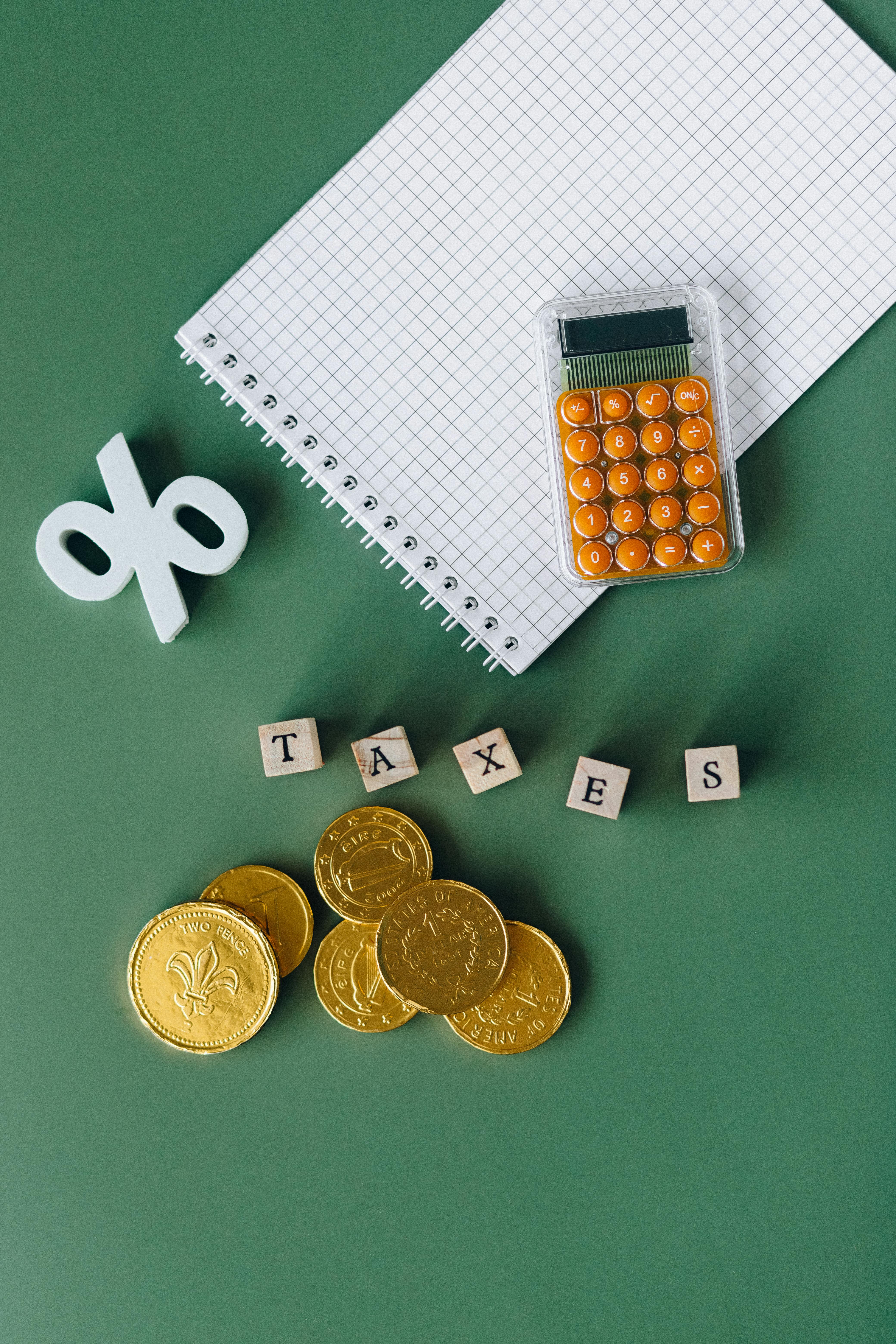 notebook and calculator on green surface