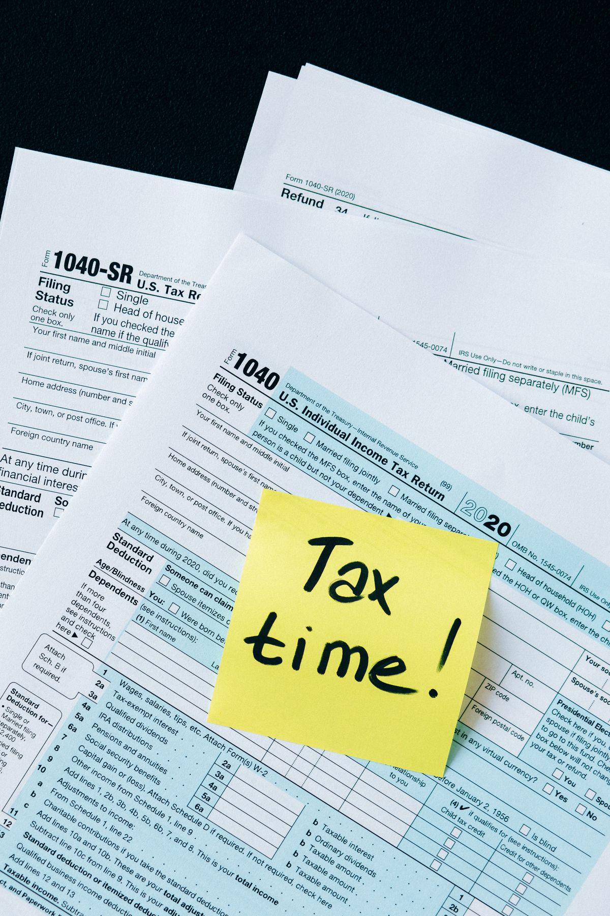 Tax and reporting documents spread across a desk, representing the 2026 1099 reporting changes
