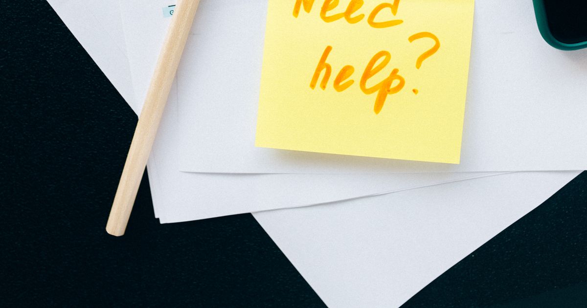 Tax forms, a calculator, and a handwritten "Need help?" sticky note representing the September 15 estimated tax deadline
