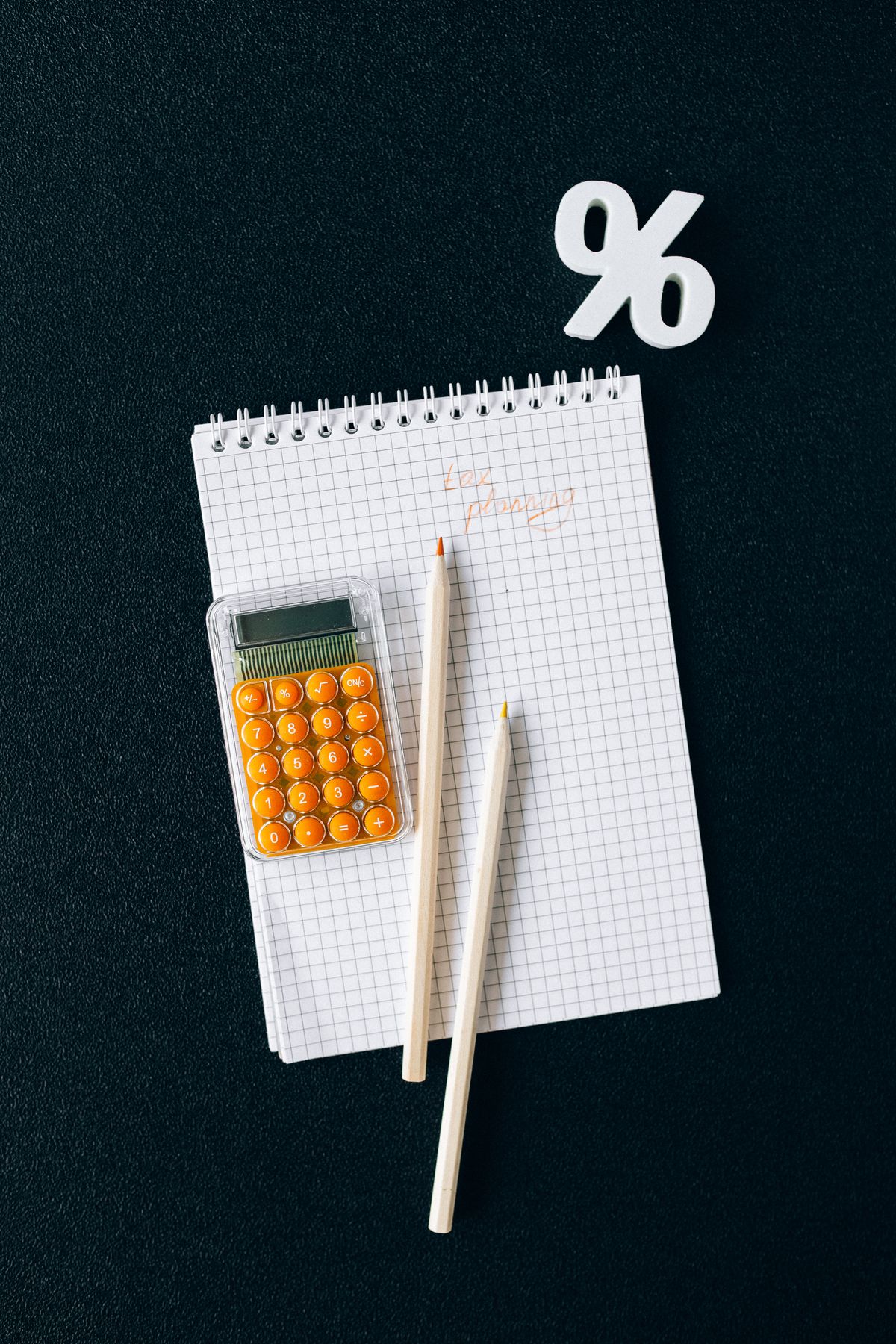 Documents and a calculator on a desk.