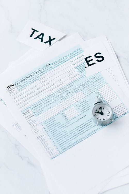 Tax Document and Round Clock on the Table