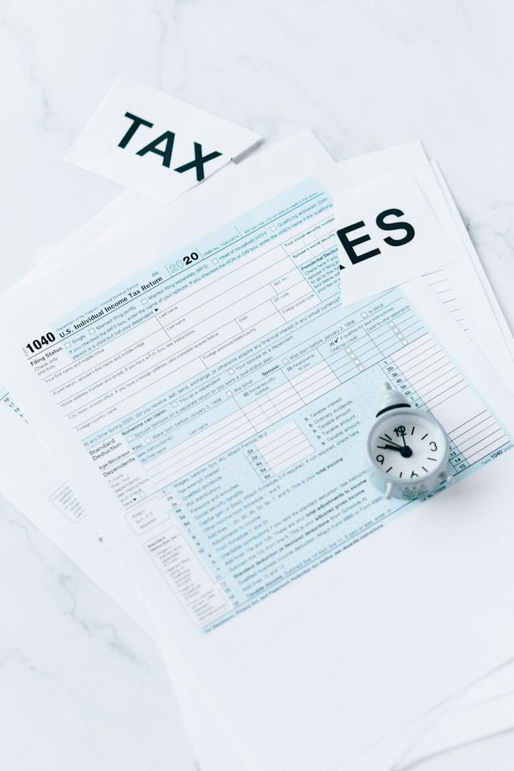 Tax Document And Round Clock On The Table