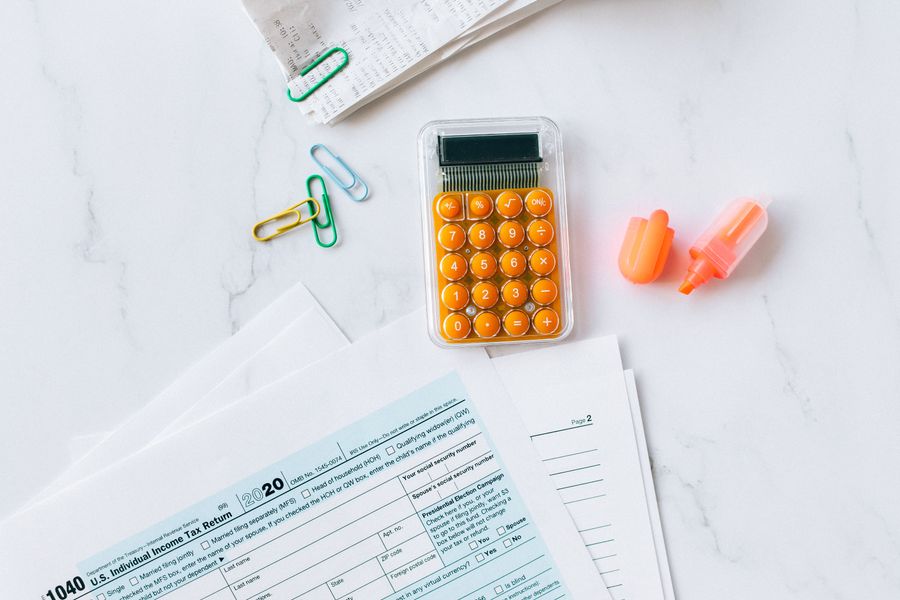 Tax forms and calculator on a desk