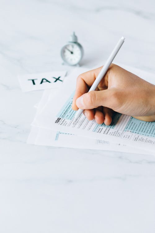 Free Person Filing Tax Documents Stock Photo