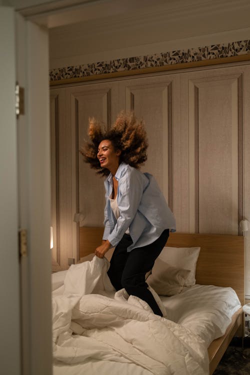 
A Woman Jumping on the Bed