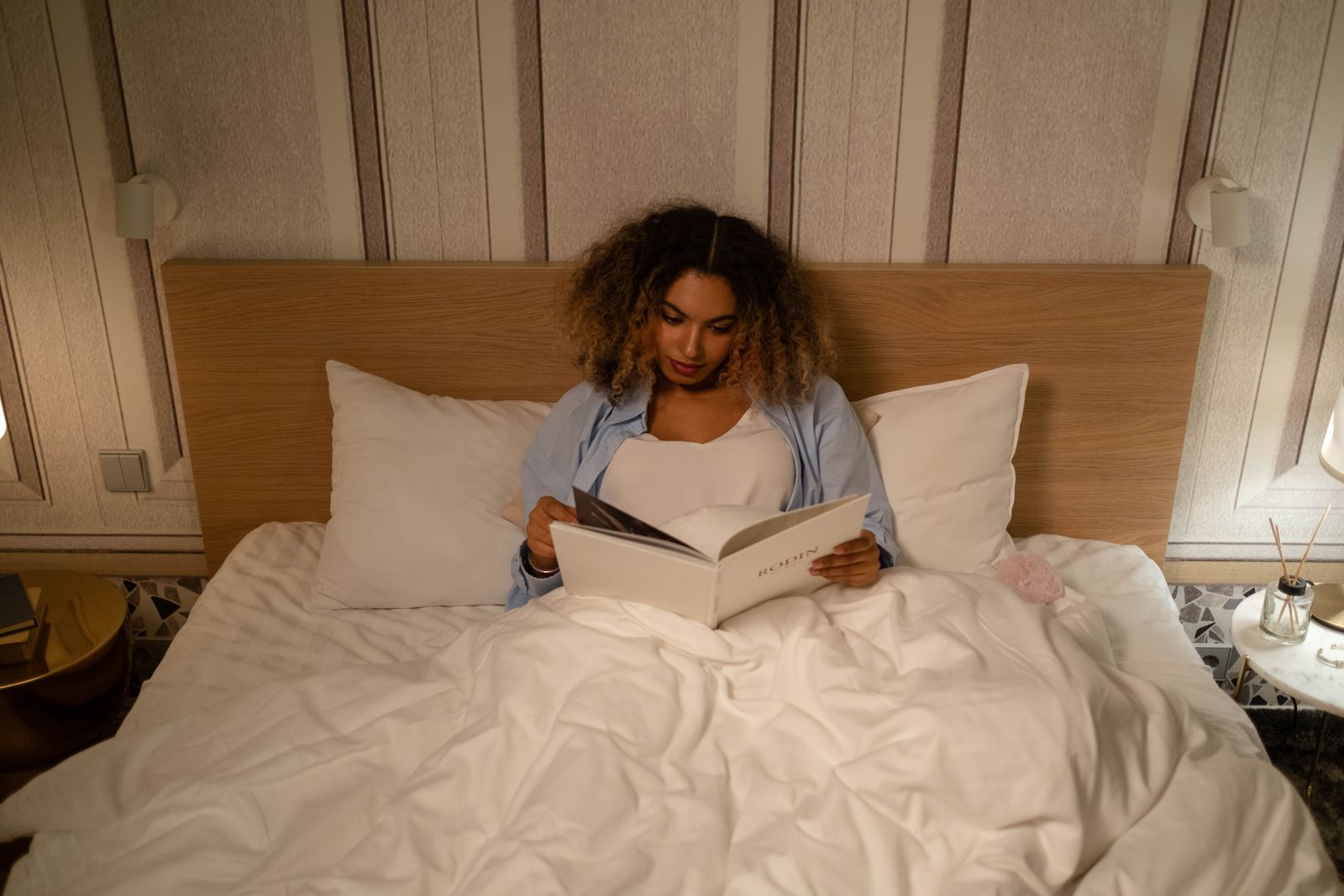 Woman reading in bed in soft cotton layers — cottonbro studio on Pexels