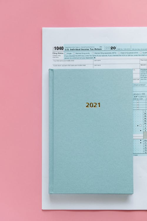 Free Tax Return Form and 2021 Planner on Pink Surface Stock Photo