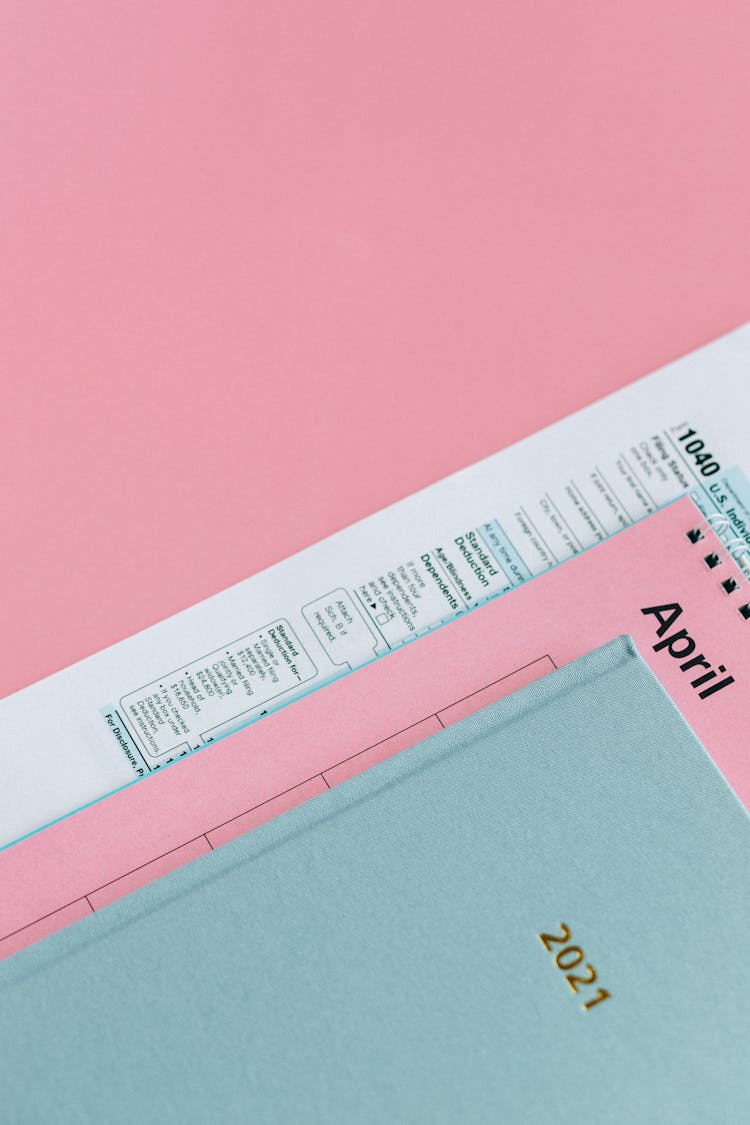 Tax Return Form And 2021 Planner On Pink Surface