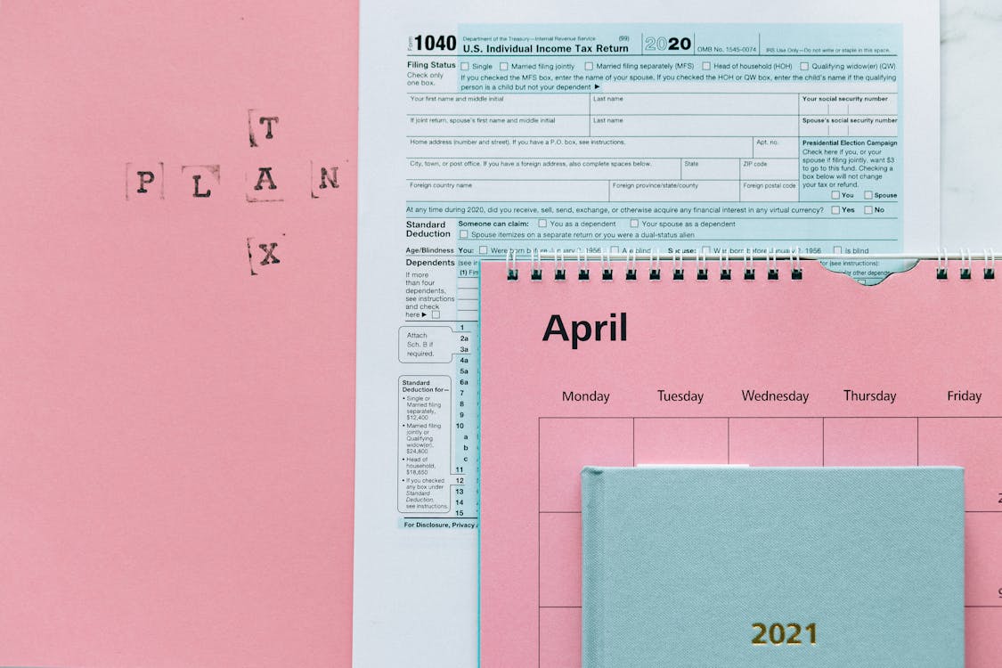 Free Tax Return Form and 2021 Planner on Pink Surface Stock Photo