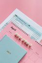 Tax Return Form and 2021 Planner on Pink Surface