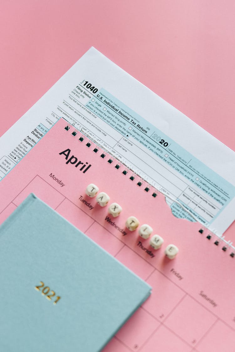 Tax Return Form And 2021 Planner On Pink Surface