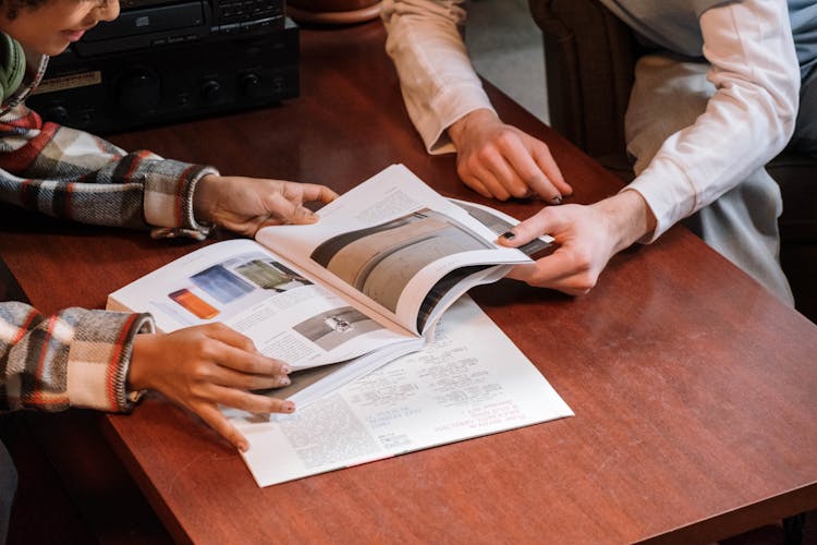 Photo Of Hands Holding A Magazine