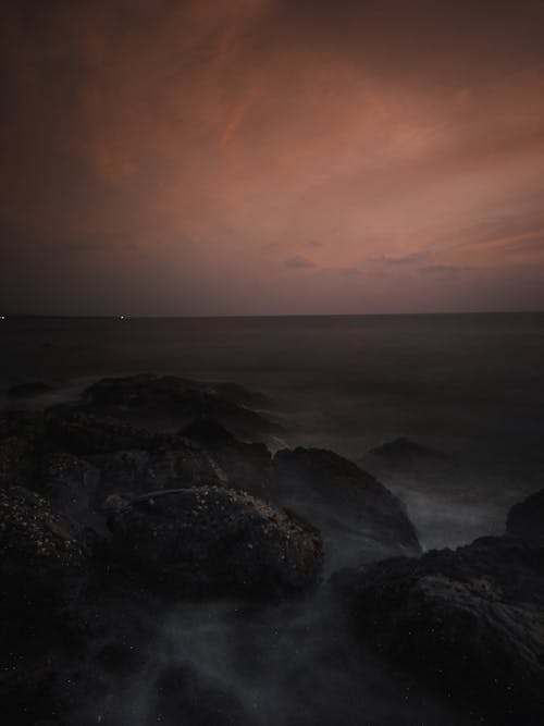 Black Rocks on Sea at Sunset