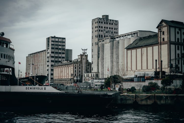 Ferry Moored On Embankment In City