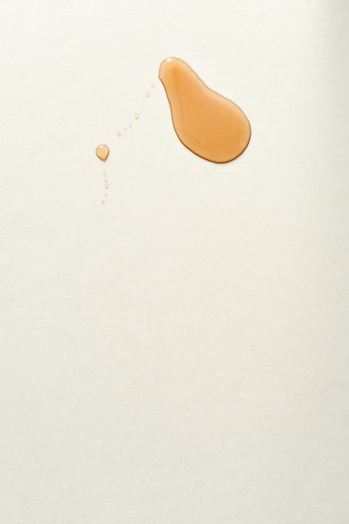 Free Close-up of a maple syrup droplet staining a white surface with copyspace. Stock Photo