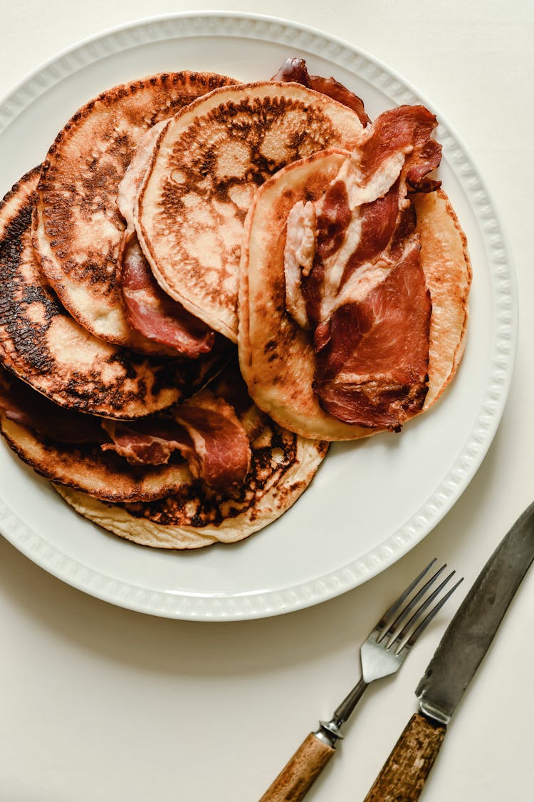 Pancakes With Bacon On White Ceramic Plate