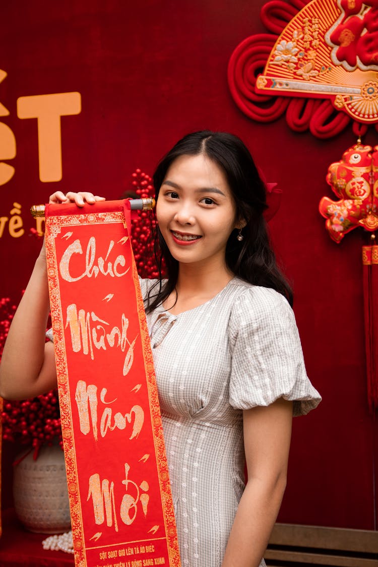 Young Woman Holding A New Year Couplet