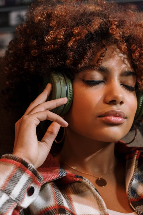 Free Woman in Plaid Shirt Wearing a Headphones Stock Photo