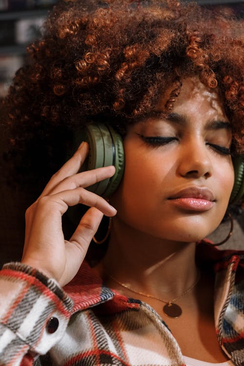 Woman in Plaid Shirt Wearing a Headphones