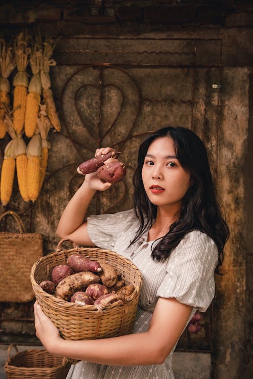 Girl Holding a Basket of Yams