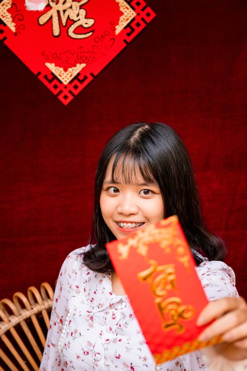 Free Woman Holding a Red Envelope Stock Photo
