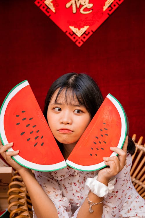 A Girl Holding a Watermelon Shaped Board