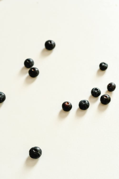 Close-Up Shot of Blueberries on a White Surface