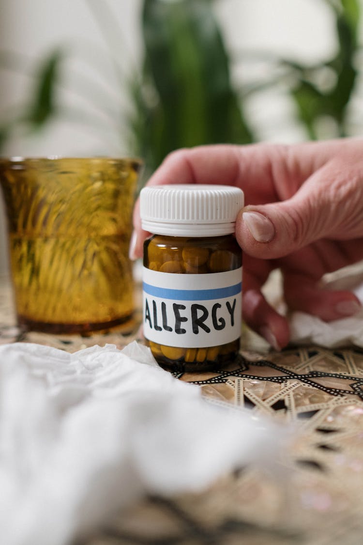 Person Holding Allergy Medicine Bottle