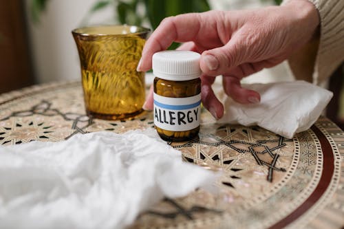 Free Person Holding Allergy Medicine Bottle Stock Photo