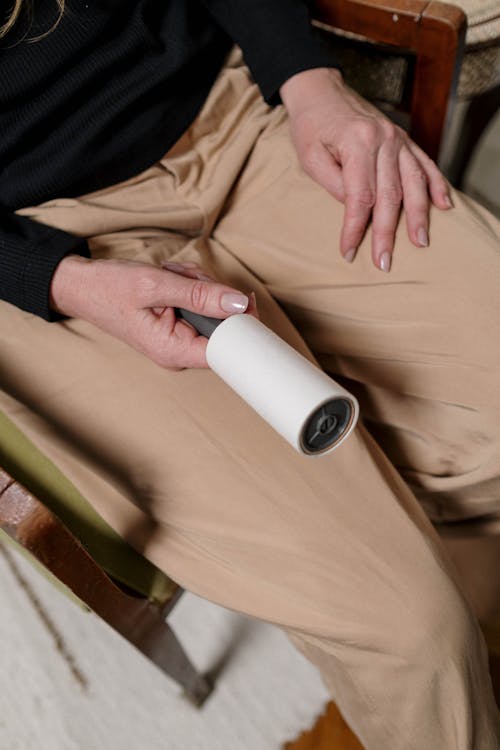 Free Person Holding a Lint Roller Stock Photo
