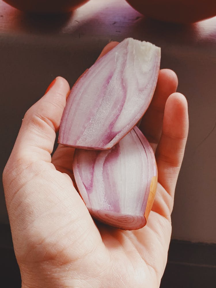 A Person Holding Sliced Shallots 