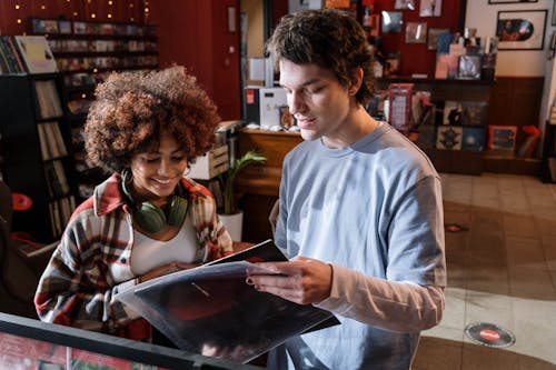 Woman and Man Looking at a Vinyl  Record