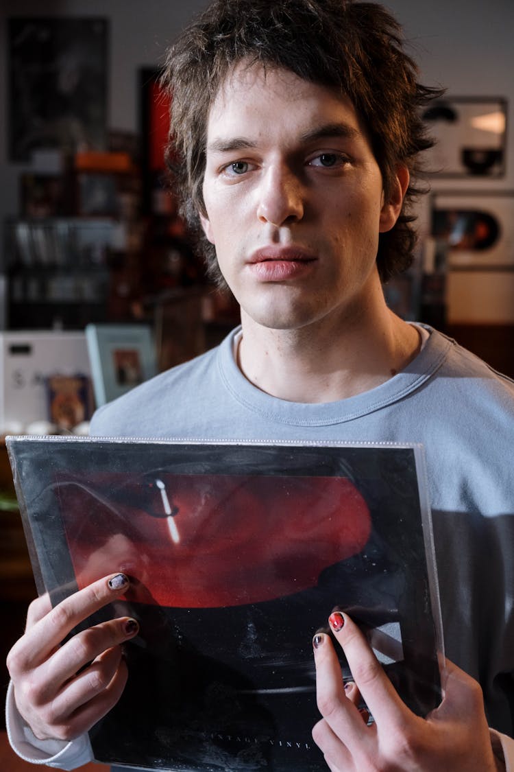 A Man Holding A Vinyl Record