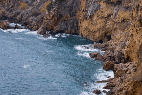 Free Crashing Waves on the Cliff Rocks Stock Photo