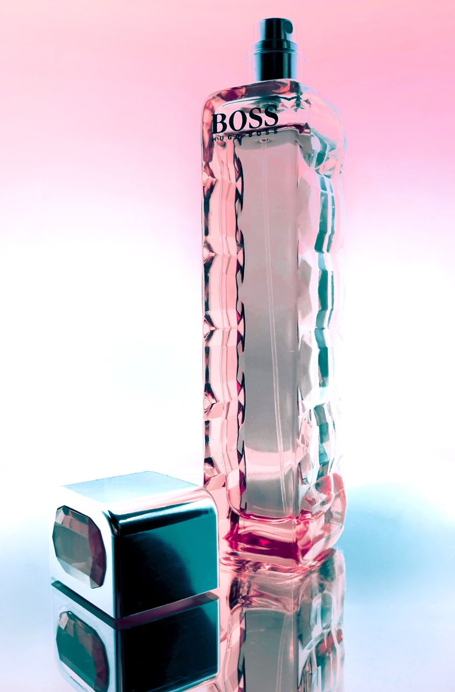 Faceted perfume bottle lit with pink and blue gels