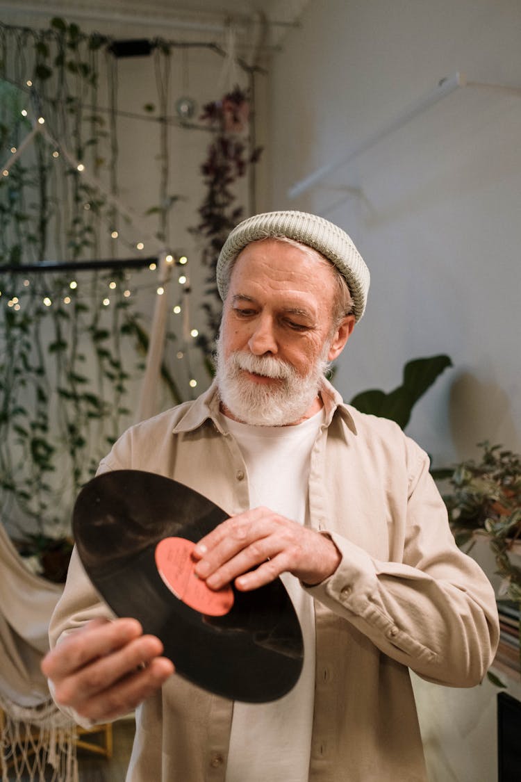 
An Elderly Man Holding A Vinyl Record