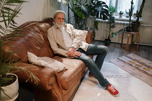 
A Bearded Elderly Man Sitting on a Couch