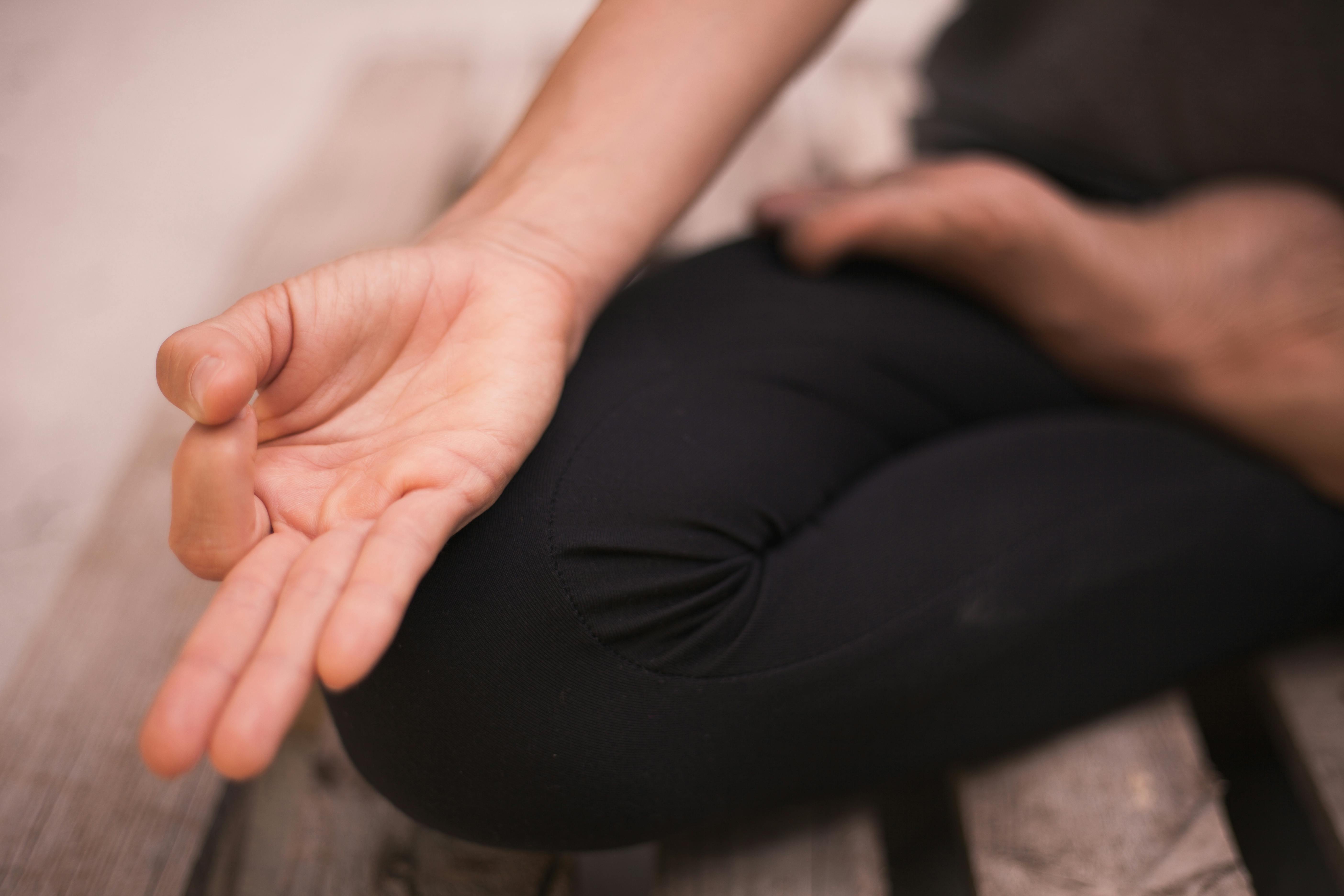 Close-up of a hand in a meditation pose, focusing on mindfulness and calmness.