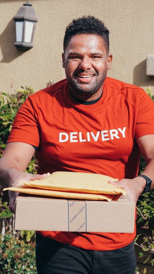Smiling Man in Red Crew Neck T-shirt Making a Delivery