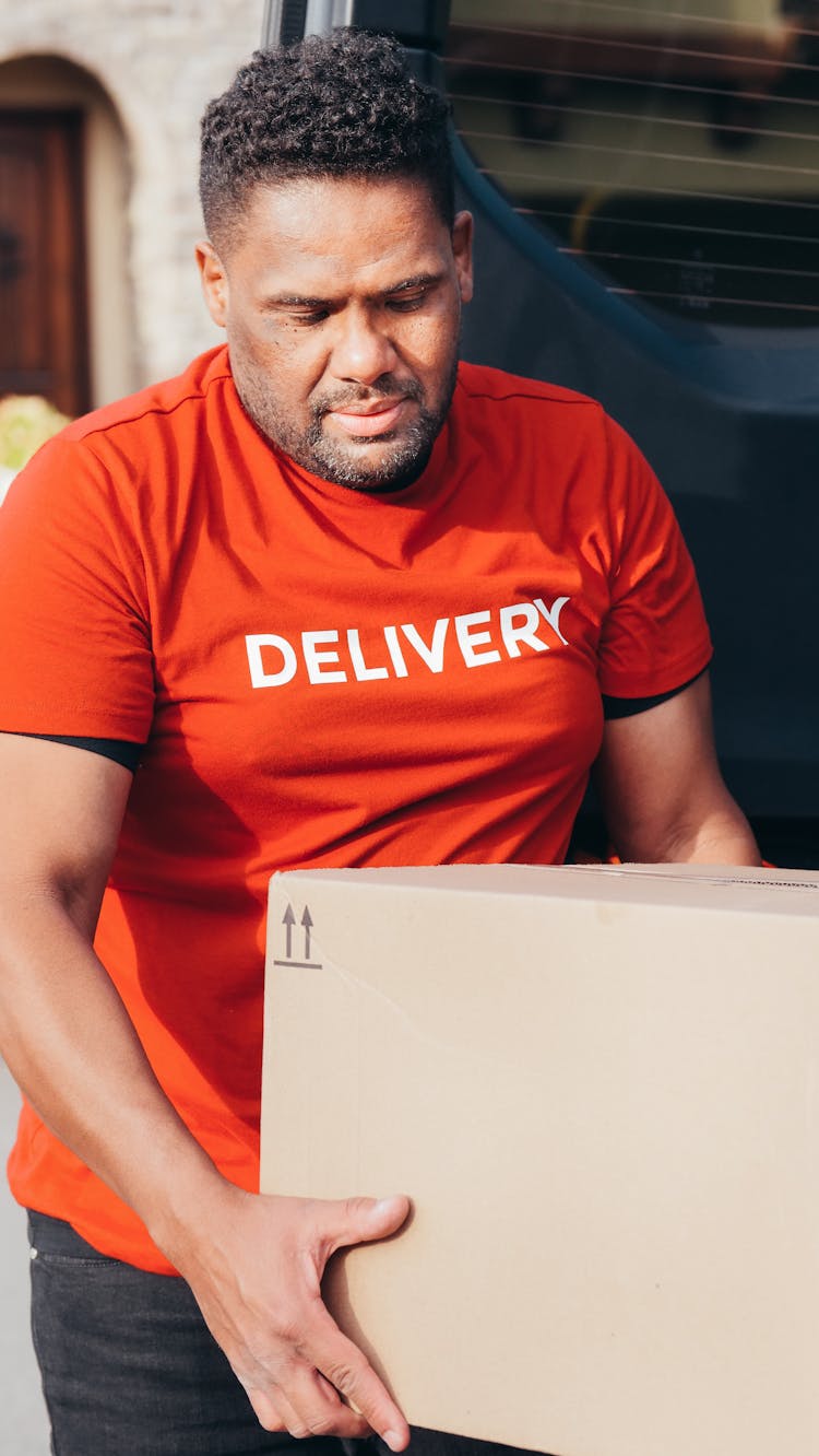 A Man Carrying A Box