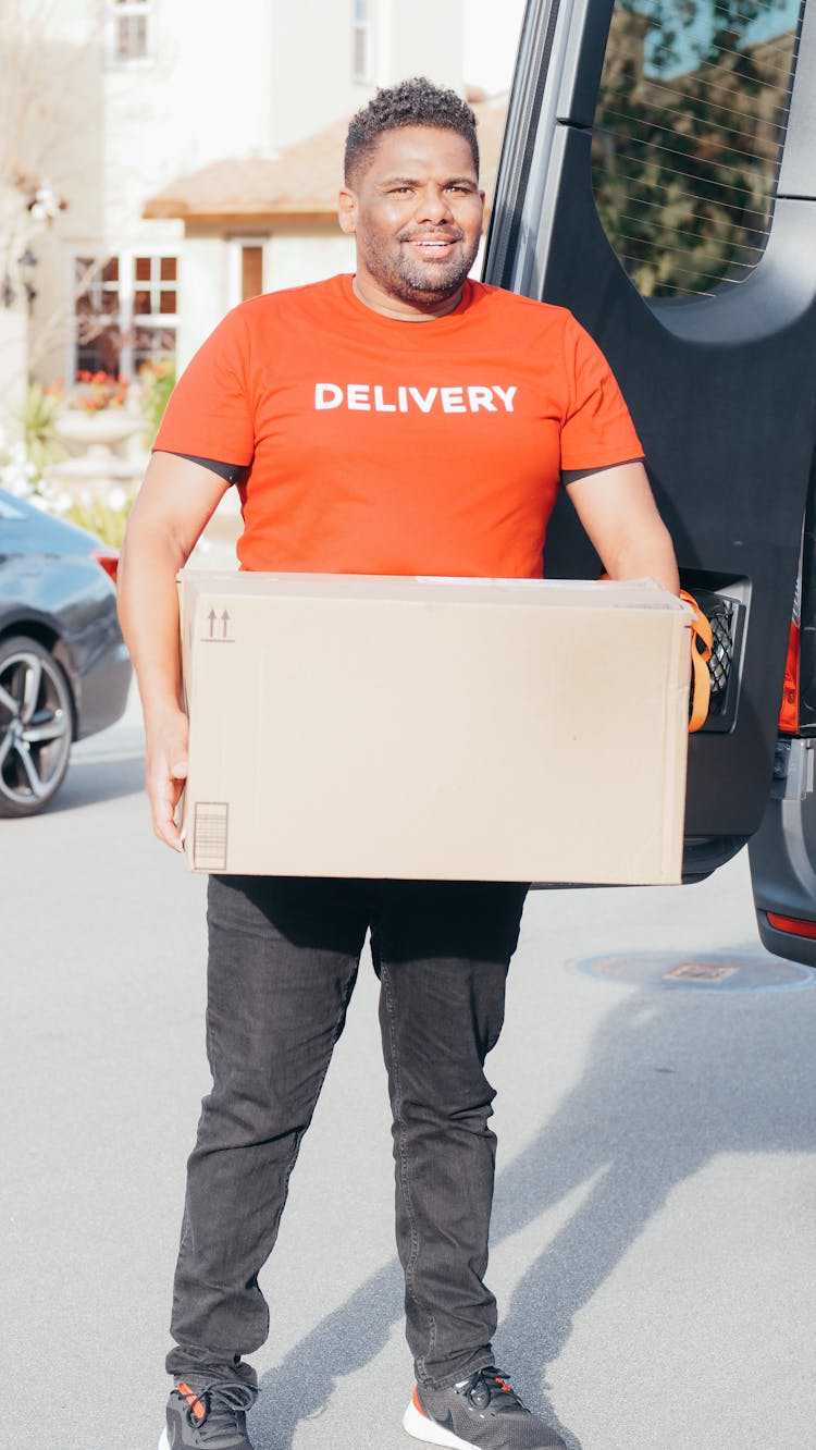 A Man Carrying A Box