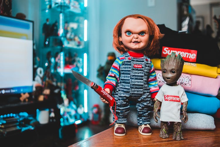 Chucky Doll And Groot Dressed In Supreme Clothing 