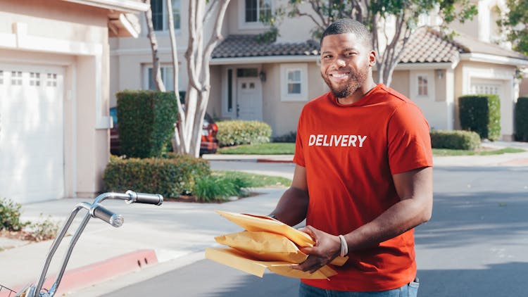 Photo Of Delivery Man Holding A Package