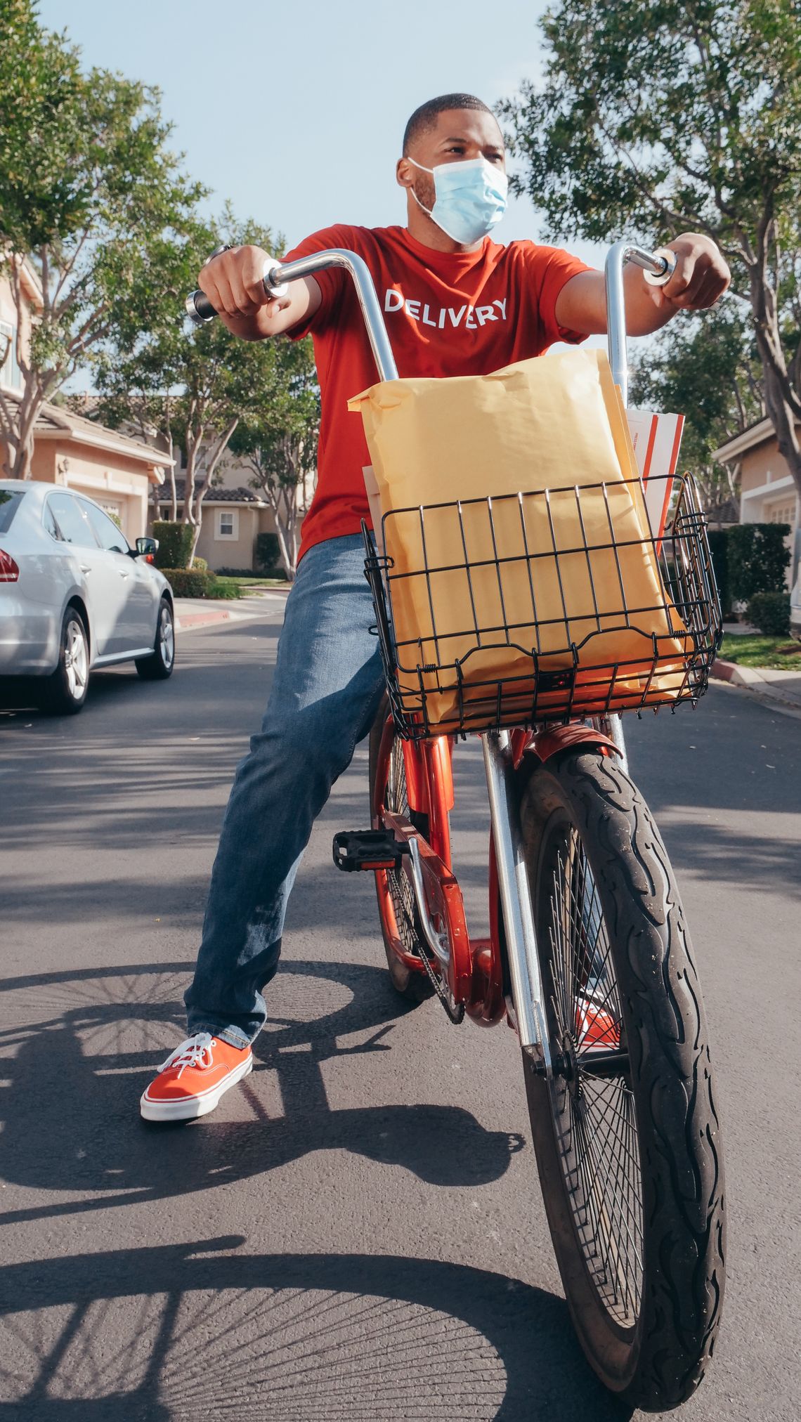 Urban bicycle courier carrying a package for delivery