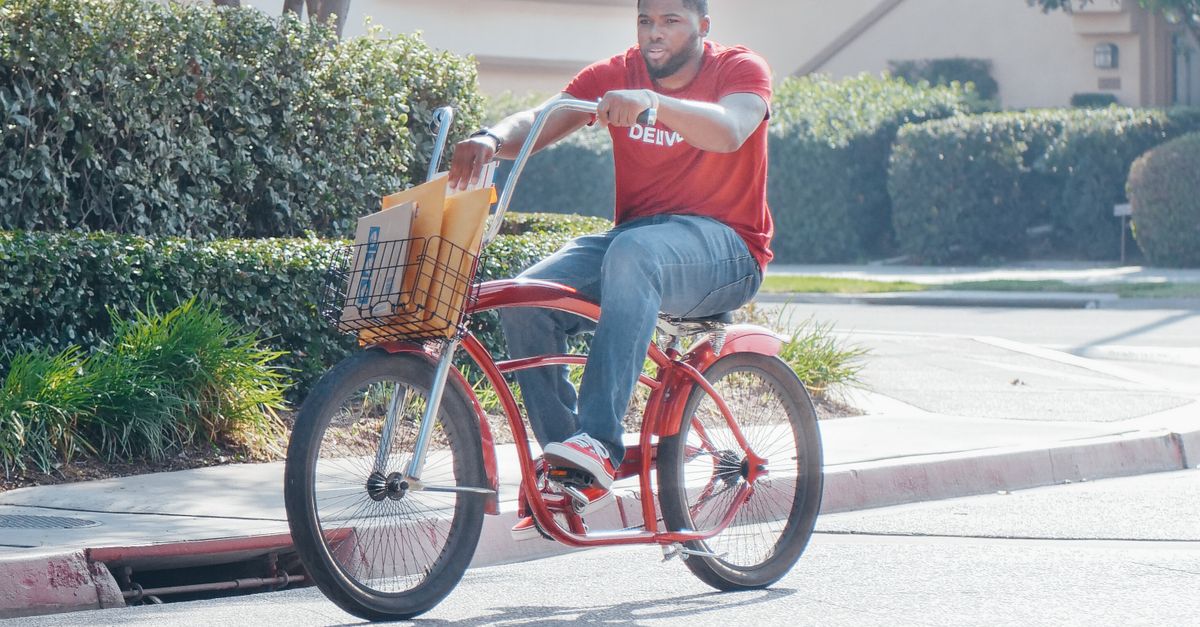 Person Riding Bike Red Man in Red Shirt Riding Red Bicycle on the Road · Free Stock Photo