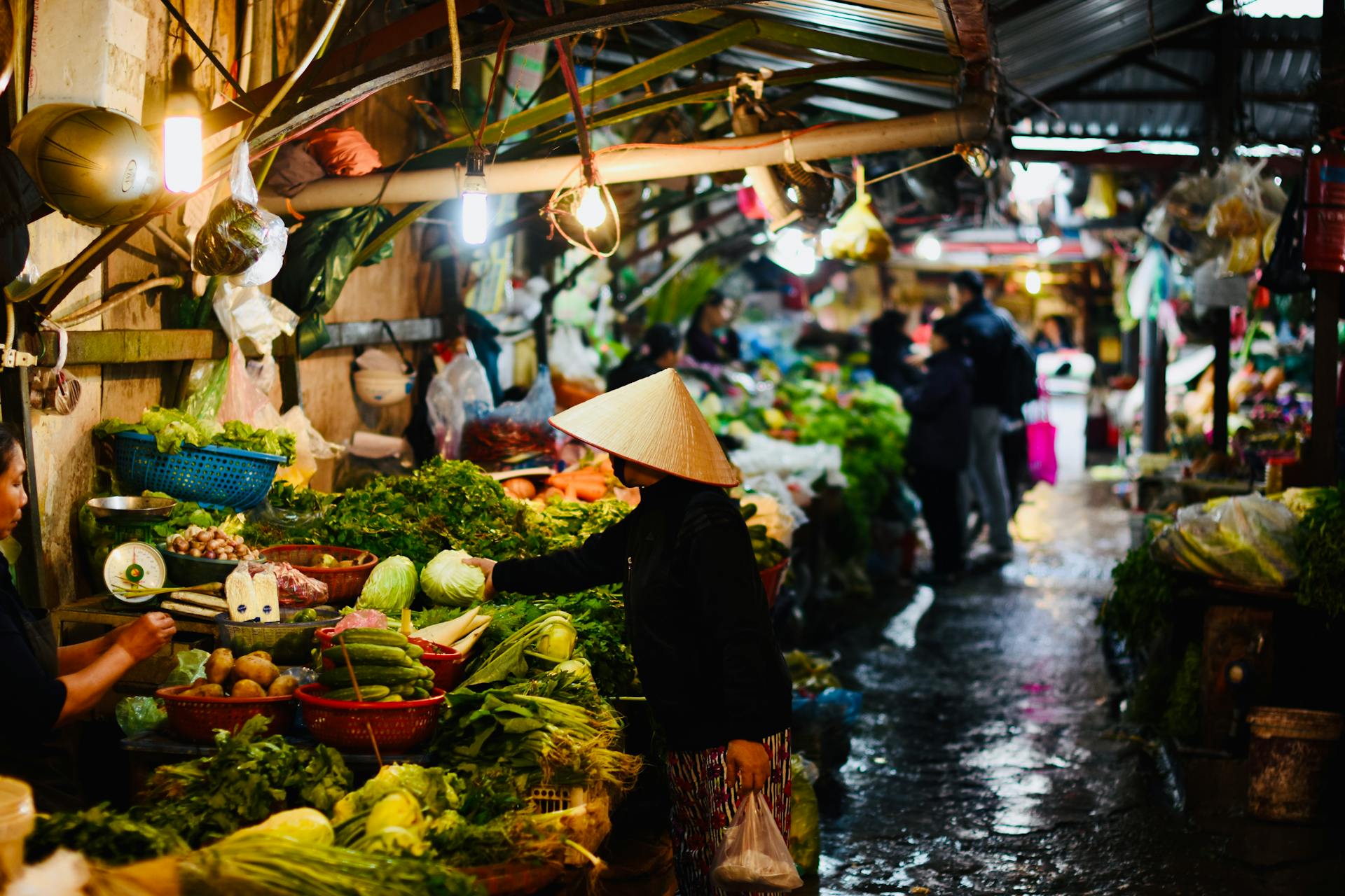 Bustling market scene with fresh vegetables and traditional merchant in Asia.