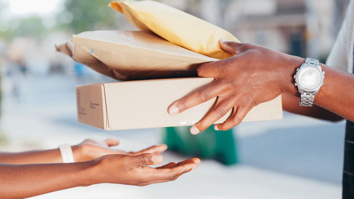 Delivery professional handing packages to a customer